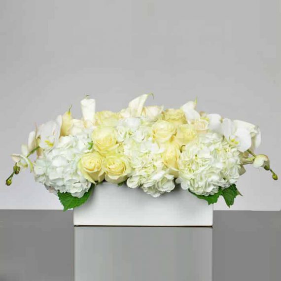 All white flowers centerpiece of phalaenopsis orchids roses and hydrangeas